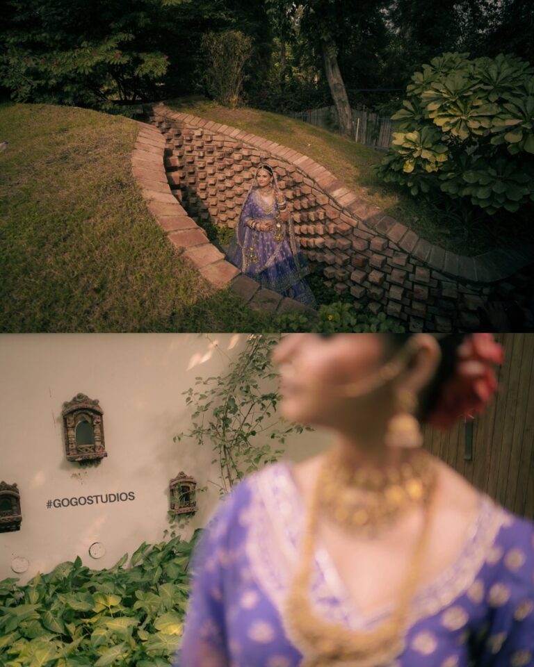 Bride in a purple lehenga sitting on the bed and adjusting her wedding jewelry in a Gurugram hotel room.